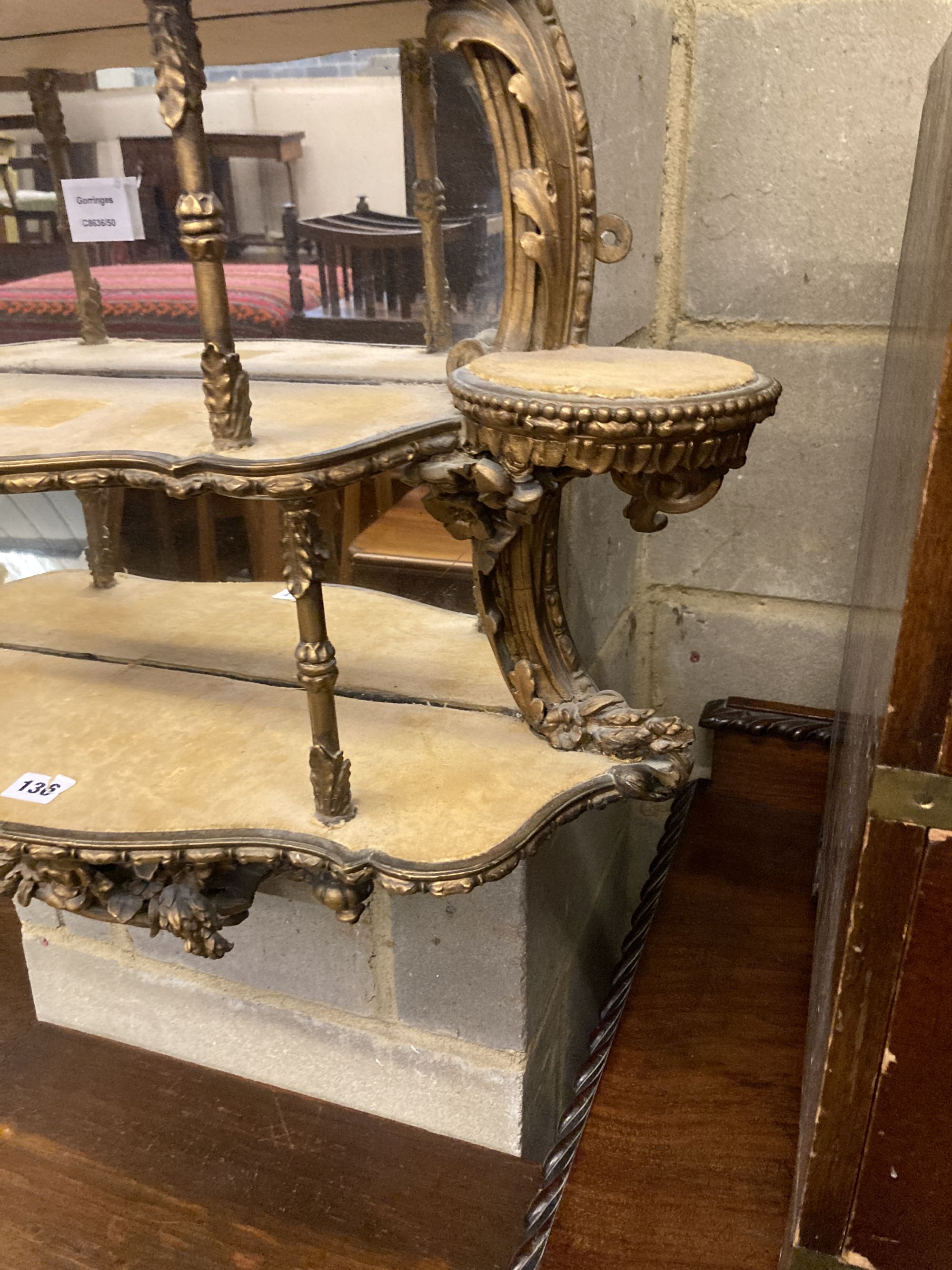 A Victorian gilt carved wood and gesso four tier mirrored bracket, width 70cm, depth 17cm, height 90cm